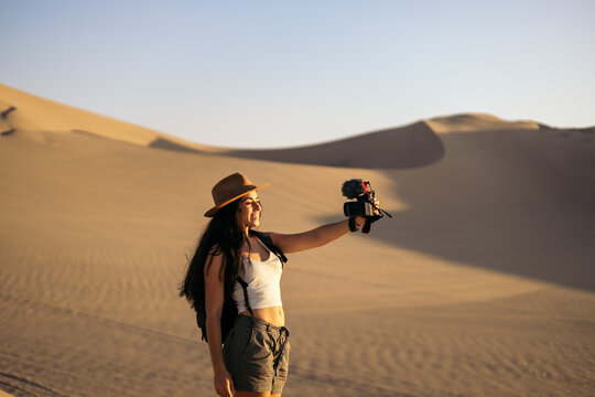 Woman video blogging in the desert