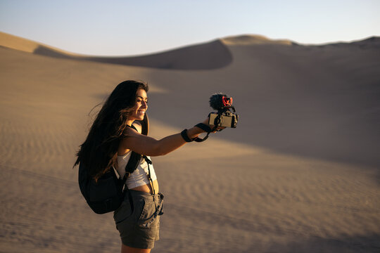Woman video blogging in the desert