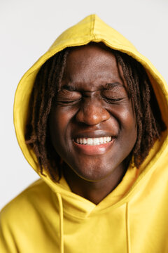 Excited male smiling with closed eyes