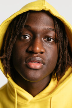 Young man with dreadlocks looking at camera