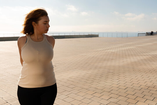 Curvy Woman stretching outdoor