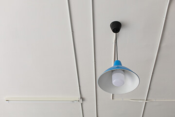 Blue electric ceiling lamp with electrical wiring conduit