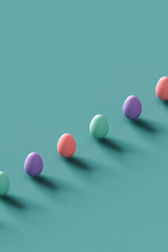 a row of Colorful Easter eggs on a pastel blue background. 3d render