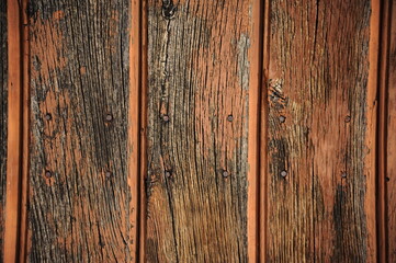 Background made of old and scruffy sessile oak planks with orange paint residue