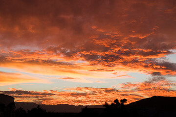 Red colored clouds illuminated by sunset light 