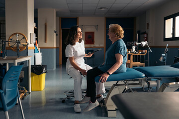 Happy female doctor and patient talking during visit