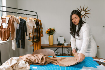 Pregnant business owner working at home