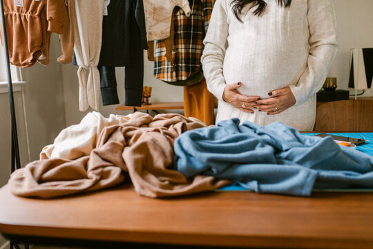 Pregnant dressmaker and airy organic fabrics tabletop