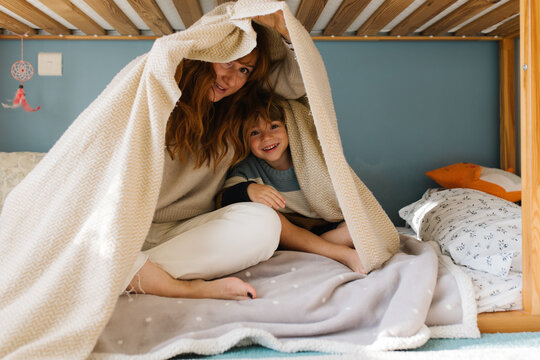 Mother and son under the blanket