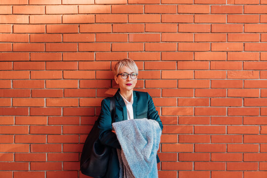 Woman in front of Brick Wall