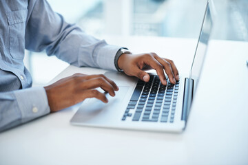 A good fibre connection produces good work. Shot of a businessman using a computer in a modern office.