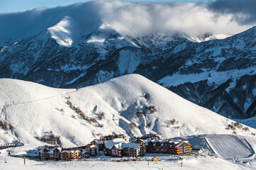 Snowy winter mountains in sun day. Georgia, from ski resort Gudauri.