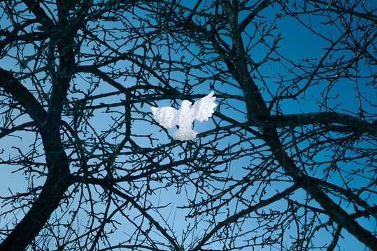 Figurine of a dove in dry branches