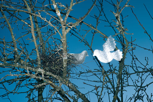 Two Figurine of a doves in dry branches