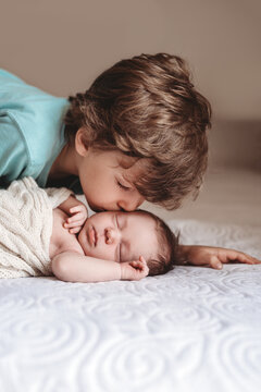 Brother kissing his baby sister