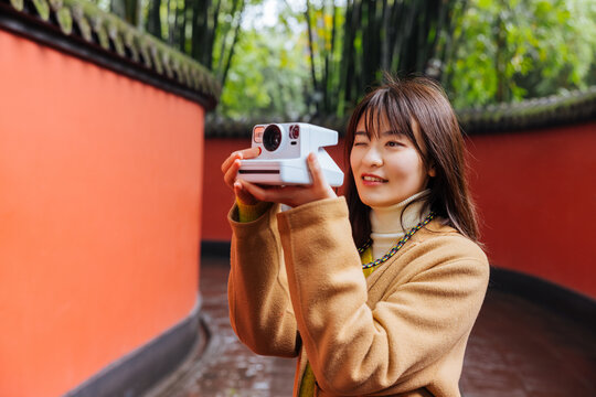 Woman using an instant camera