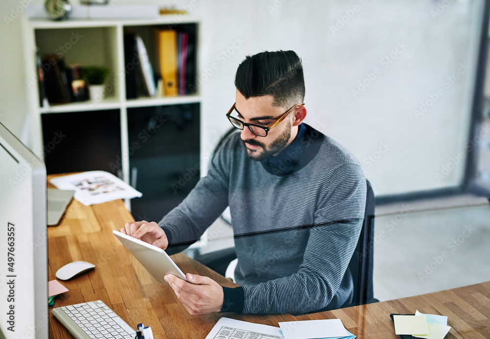 Poster give your business a boost with the right tools. shot of a young designer working on a digital table
