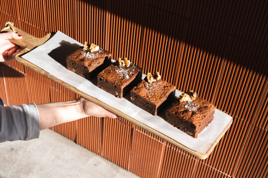 Baker with freshly baked brownie