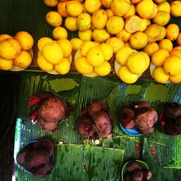 Lemons and beetroot on palm leaves for sale 