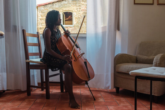 Girl with cello taking a break