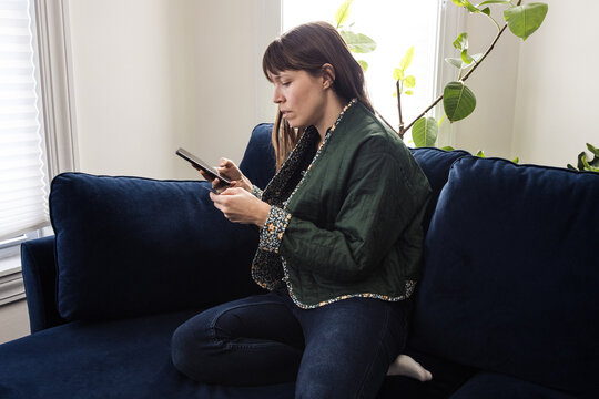 Woman using credit card by phone
