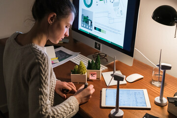 Woman working from home at night