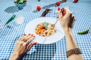 Female Hands twisting bolognese spaghetti with fork.