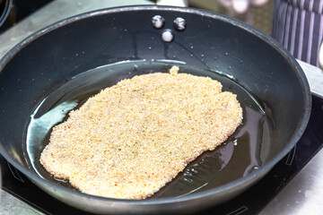Preparation of Viennese schnitzel from thin veal in breadcrumbs