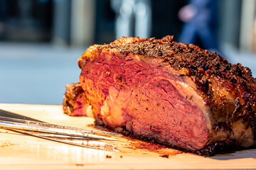 Baked roast beef from rib eye of marbled beef lies on the board