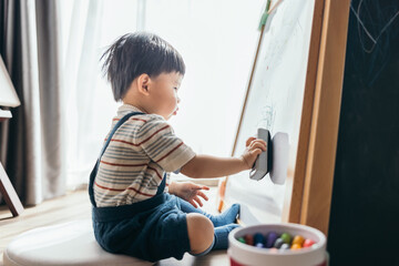 Asian little baby boy drawing