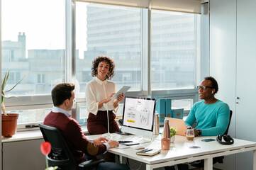 Happy diverse colleagues working on project in office