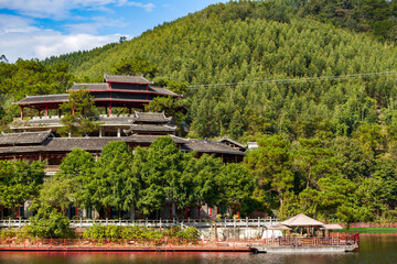 Fototapeta na wymiar The ancient architecture of the Chinese-style garden Qiaojiaolou in the mountains and forests