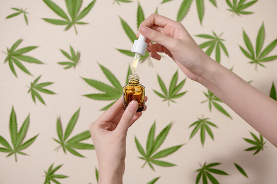Hand holding a bottle of hemp oil, CBD, canabis or canabidiol