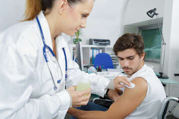 doctor in protective gloves making woman an injection