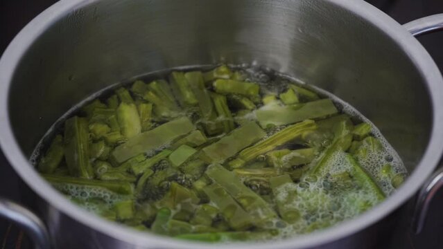 Cactus cacti food gently simmering in boiling water cooking. A traditional native Mexican dish and street food also known as nopal or nopales. Close up. 4K.