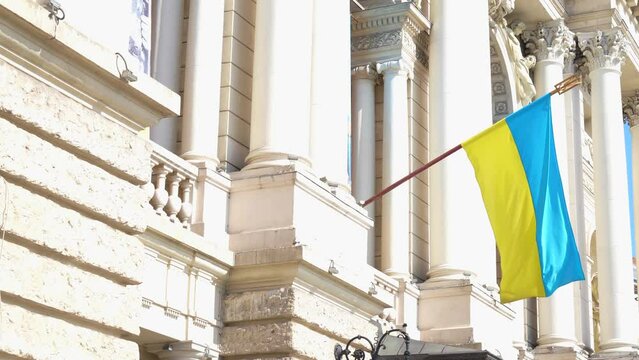 blue and yellow Ukrainian flag near building  Lviv during war