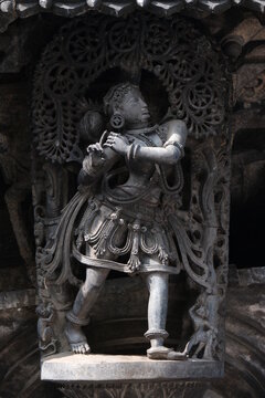 Stone Sculpture of Beautiful Female (Madanikas) with selective focus, 12th century Hindu temple, Ancient stone art and sculptures in each pillars, Chennakeshava Temple, Belur, Karnataka, India.