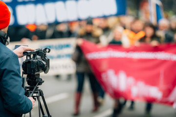 Making news, media cameraman at a public protest