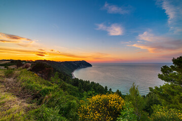 Sunset landscape Conero natural park dramatic coast headland rocky cliff adriatic sea beautiful sky...
