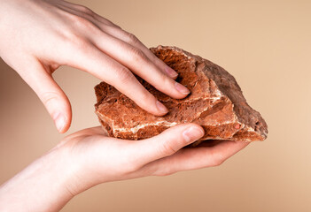 Woman hands holding red stone. Sense of touch and receiving tactile information about world...