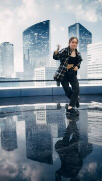 Vertical Screen: Stylish Young Professional Female Dancer Performing a Hip Hop Dance Routine in Front of Big Led Wall Screen with Modern City Skyline with Office Skyscrapers in Studio Environment.