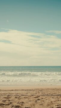 Vertical Screen: Magnificent Blue Ocean Shore Location for Tourists. Beautiful and Powerful Wild Nature and Seashore. Travel Guide Spot. Warm Beach with Golden Sand at the Sea. Day with Light Clouds.