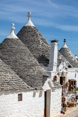 Tradtional white houses in Trulli village. Alberobello, Italy. The style of construction is...