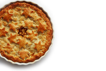 Apple Pie with double crust with cinnamon made with shortcrust pastry isolated on white background with star shape decoration