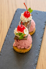 Fruit ice cream served with maraschino cherries