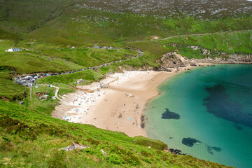 View on Keem beach, Achill island, Ireland. Warm sunny day. Full car park. Travel and tourism...