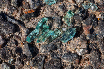 broken glass on the asphalt after an accident with a car