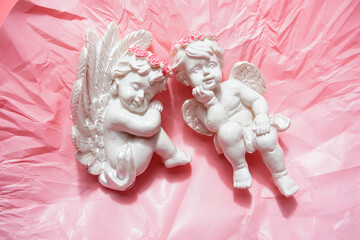 Happy Valentine’s Day.Little angel on pink background.Lot of copy space.Beautiful cupid.