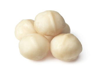 Unshelled macadamia nuts isolated on white background.
