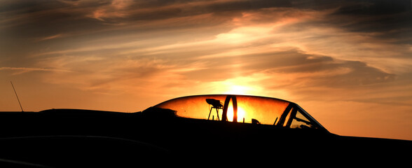Fototapeta na wymiar Late evening sun through aircraft cockpit hood in air museum.